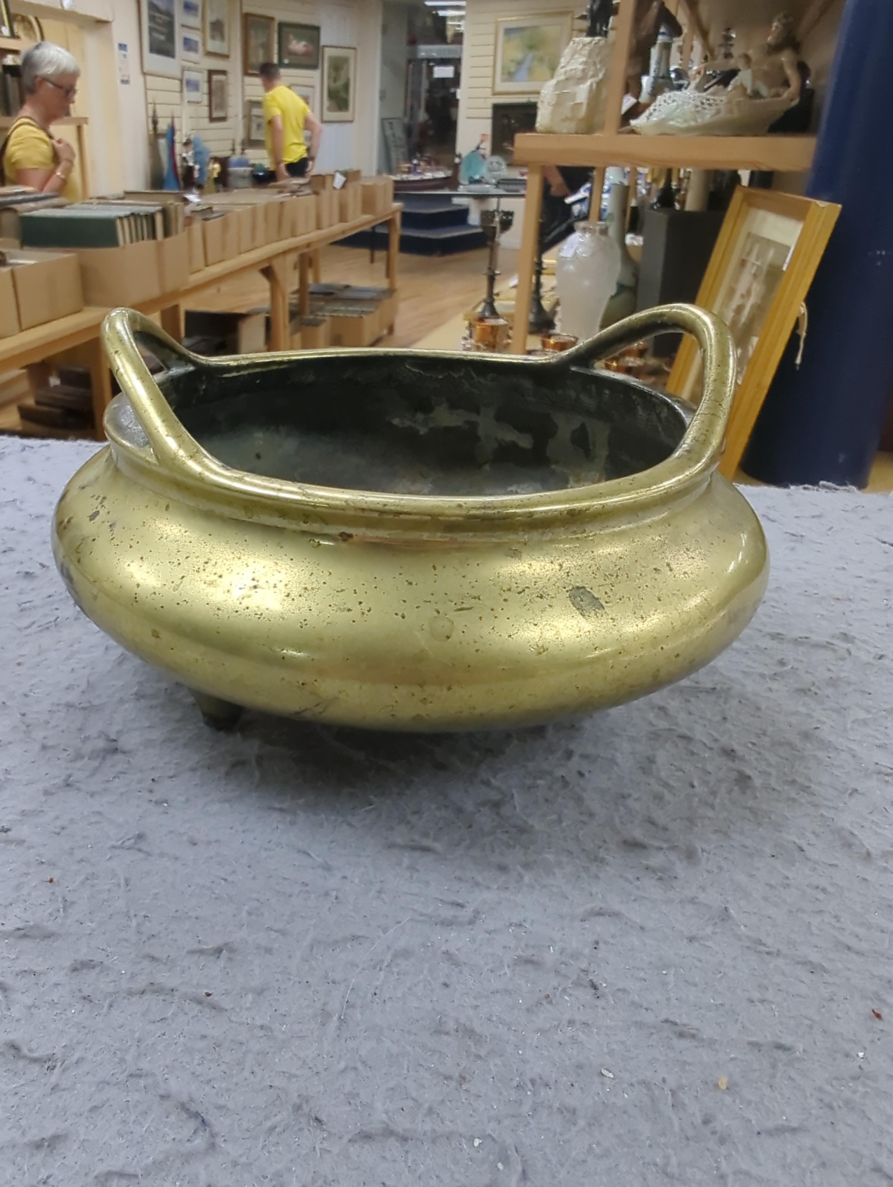 A late 19th century Chinese bronze censer with twin handles, apocryphal Xuande mark, 17.5cm in diameter